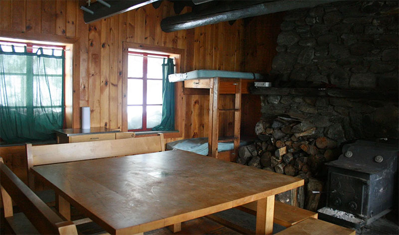 The interior of the hut, with table and stove