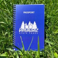 The 100th anniversary Parks Passport on green grass