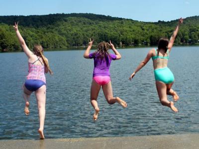 Kids jump into a lake